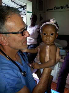 Pediatrician Dr. Elliot Barsh seeing a young patient in Haiti