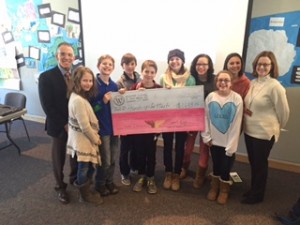 The Student Council presents a check to Drs. Ratner and Barsh for Hands Up for Haiti.