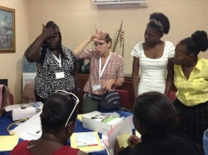 Learning to take temperature. Dr. Leah Greenspan Hodor and a group of health care professionals.