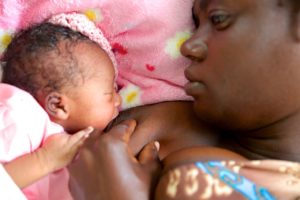 Woman feeding newborn